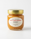 A 250 g jar of Eat Raw Honey raw creamed hot chili pepper honey